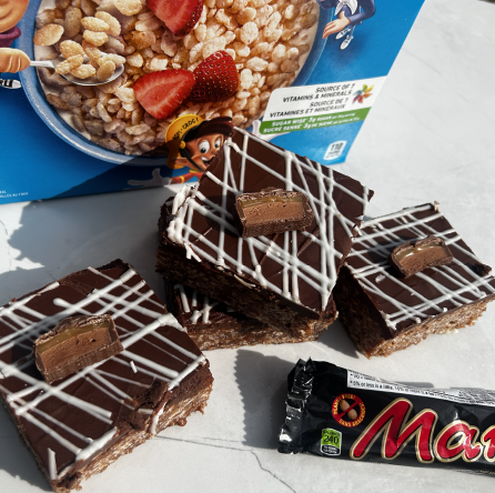 Chocolate-covered Mars Bar squares with white drizzle.